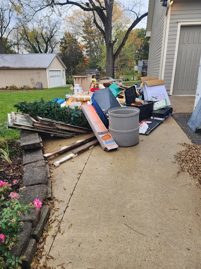 Dumpster being loaded with debris for Estate Cleanout Dumpster Rental in Culpeper